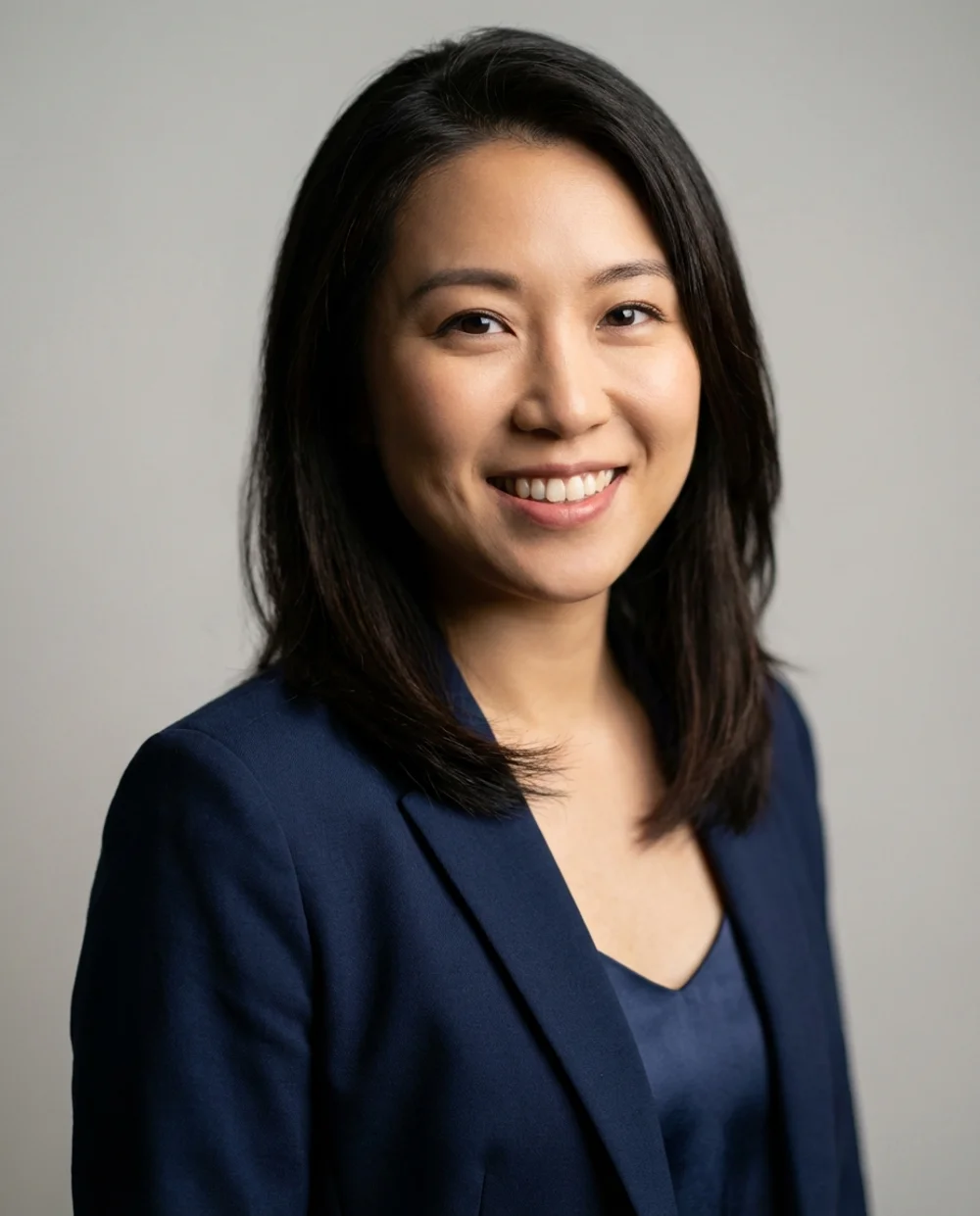 Professional business headshot - woman in navy blazer